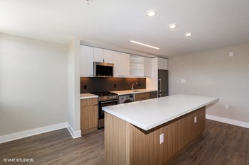 a kitchen with white countertops and wooden cabinets a kitchen with white countertops and wooden cabinets