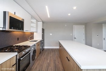 a kitchen with white countertops and white cabinets