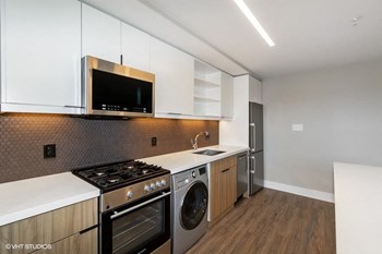 a kitchen with white cabinets and stainless steel appliances a kitchen with white cabinets and stainless steel appliances
