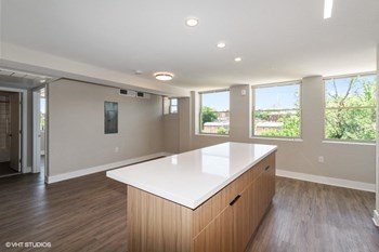 a kitchen with a large island in the middle of a room a kitchen with a large island in the middle of a room