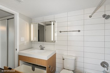 a bathroom with a toilet sink and mirror - Photo Gallery 15