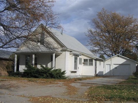 a white house with a road in front of it