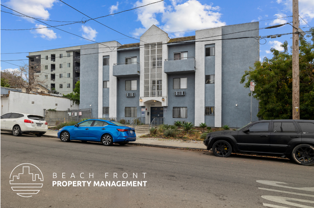 a large apartment building with cars parked in front of it