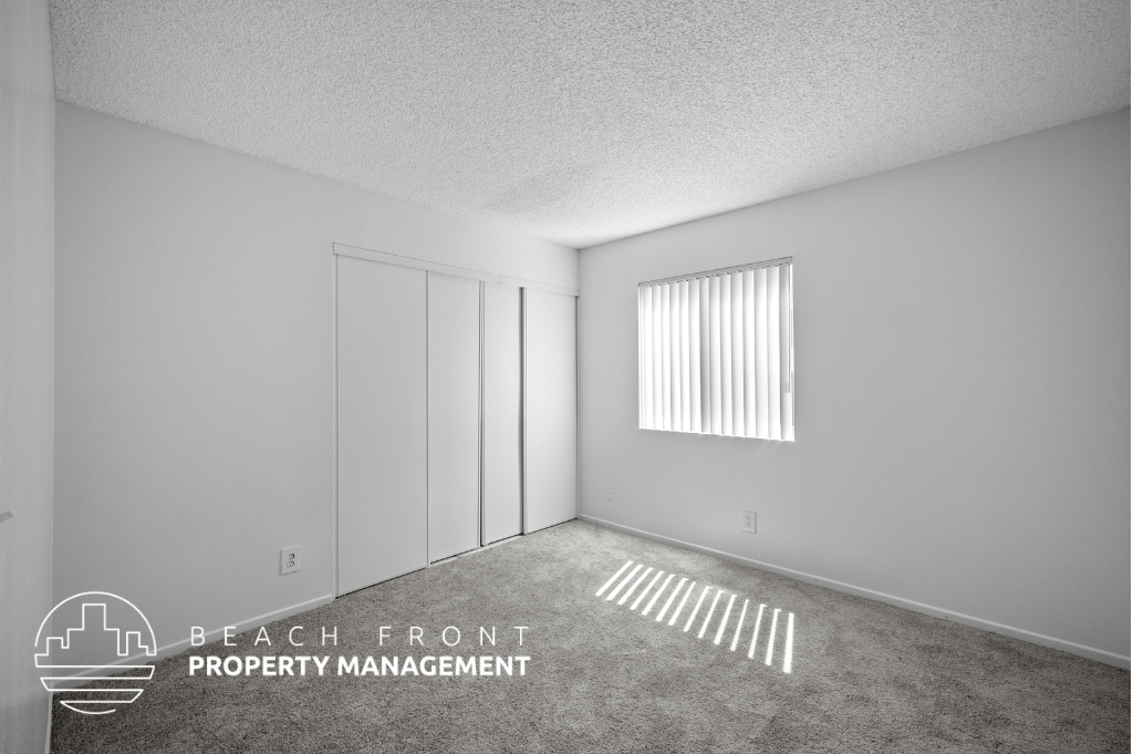 an empty room with a window and a radiator on the floor