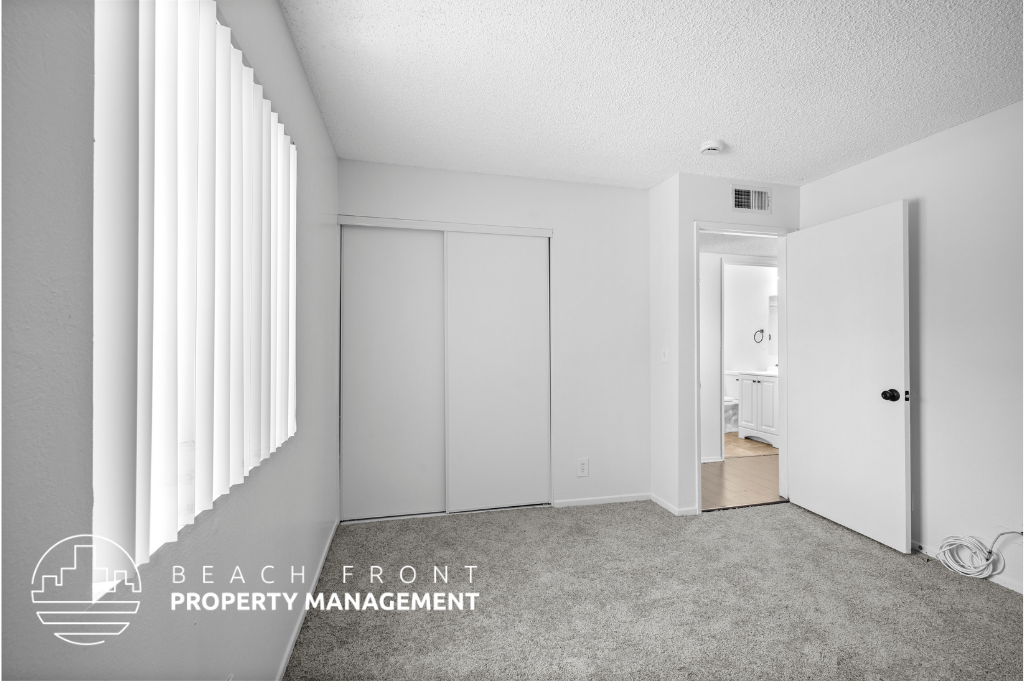 a master bedroom with a closet and a door to a bathroom