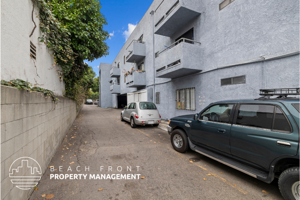 a parking lot with cars parked in front of a building