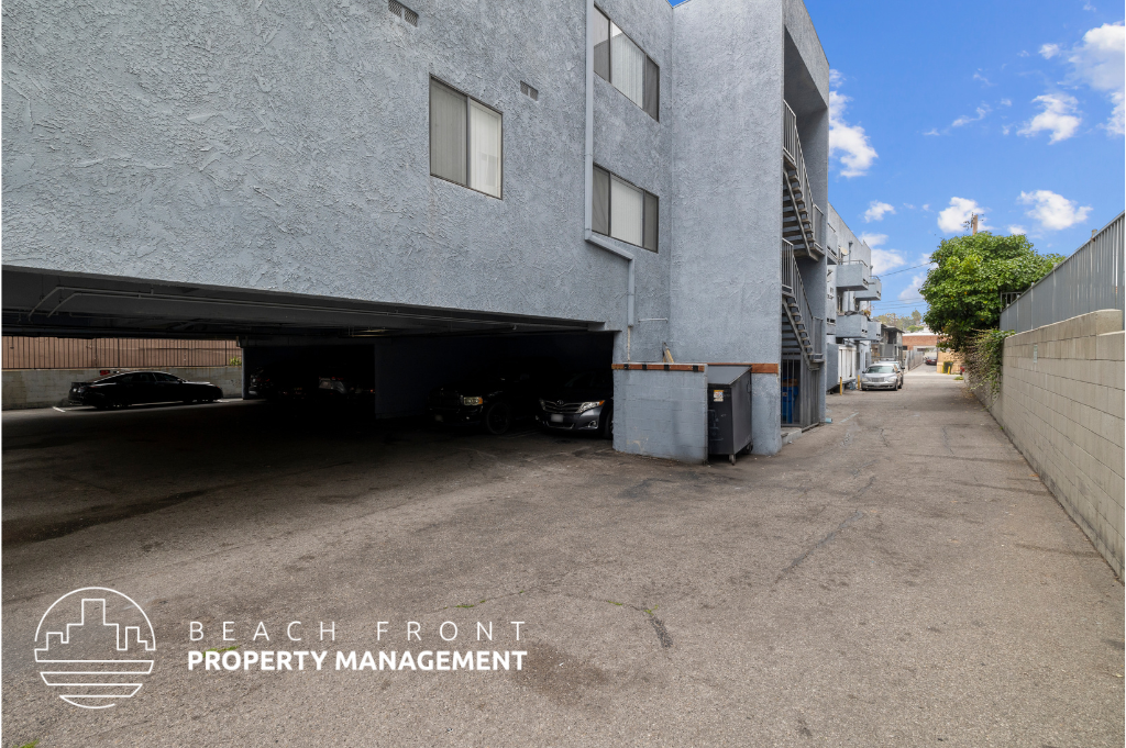 a parking garage in front of a building with a car in it