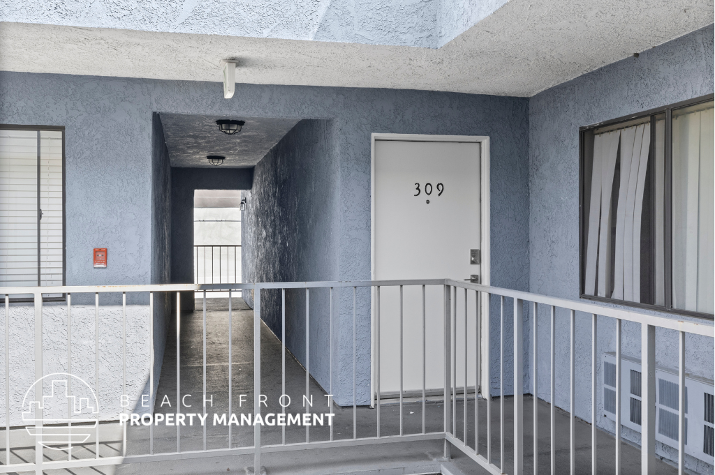a view of a corridor in a building with a white door