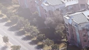 an aerial view of a city street with buildings and cars