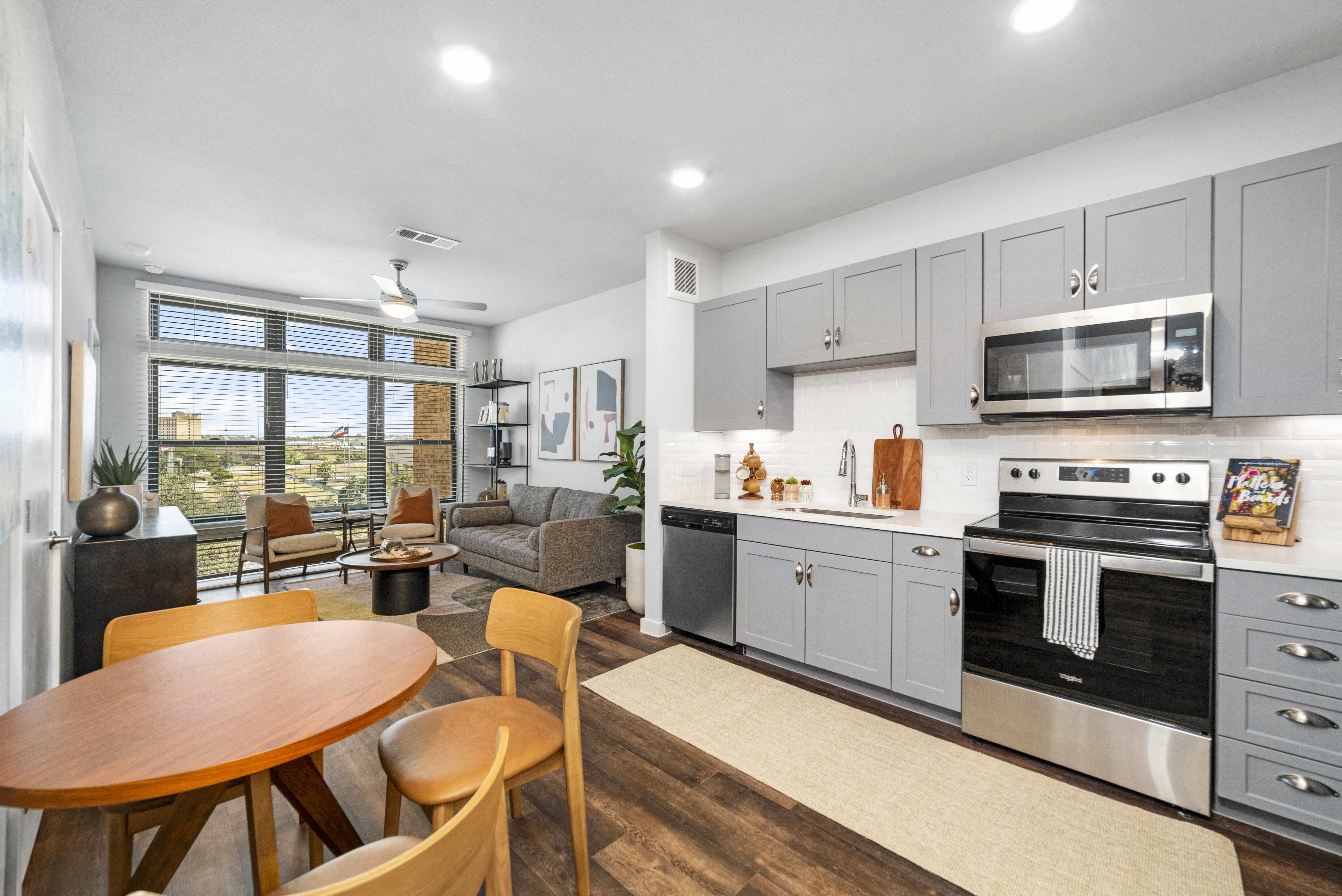 an open kitchen and living room with a table and chairs