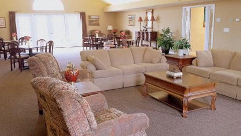 a living room with couches and chairs and a table