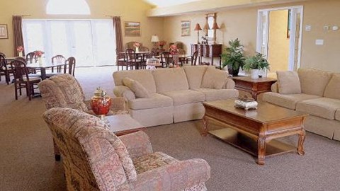 a living room with couches and chairs and a table