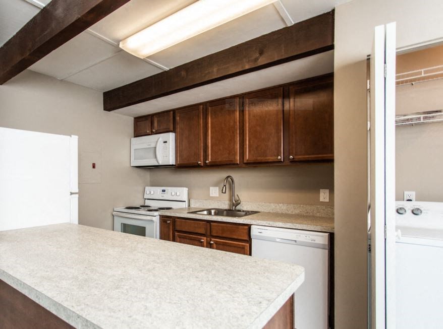 a kitchen with white appliances and a counter top