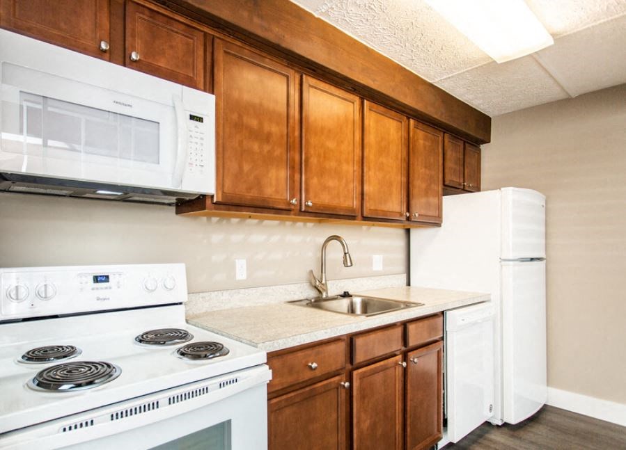 a kitchen with a stove microwave and a sink