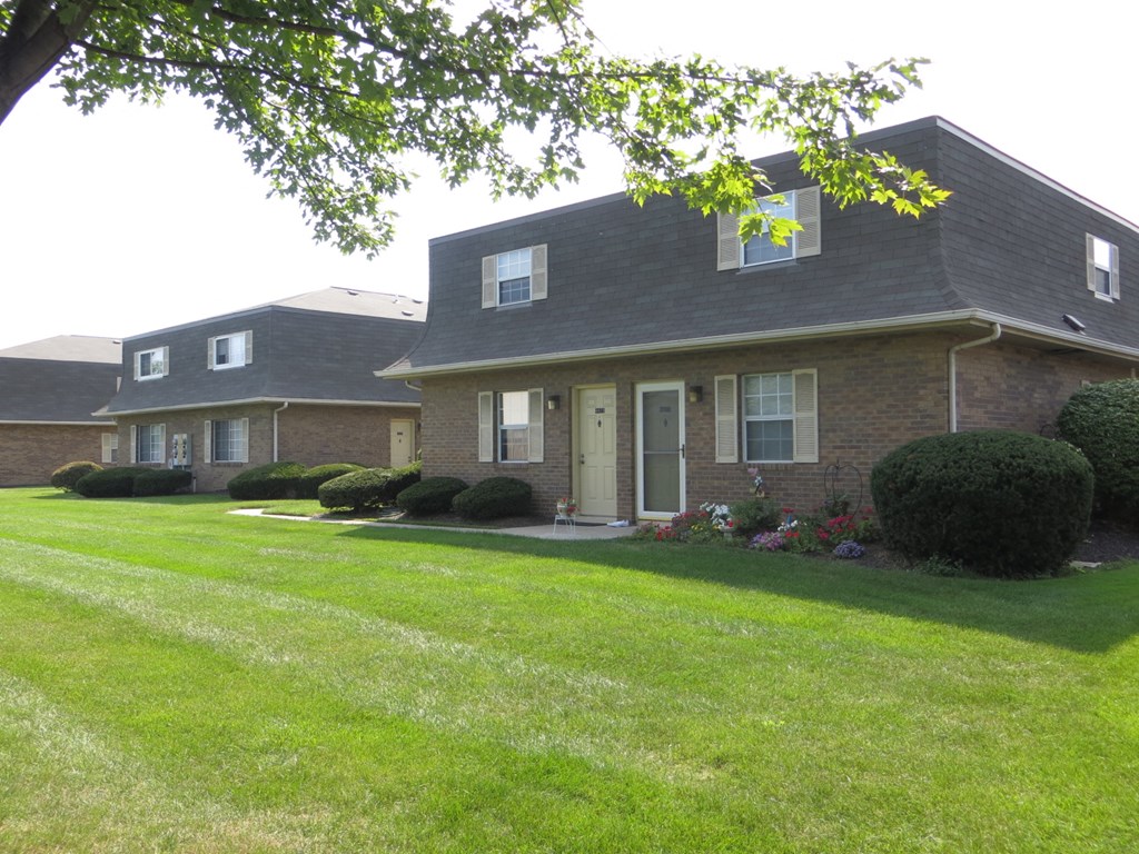 a view of the front of a house with a lawn