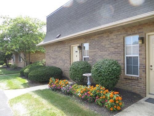 a house with a flower garden in front of it