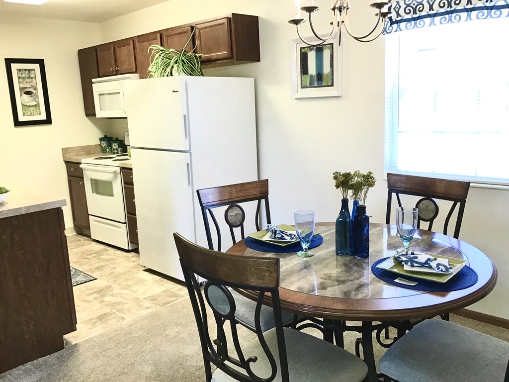 a kitchen and dining area with a table and chairs