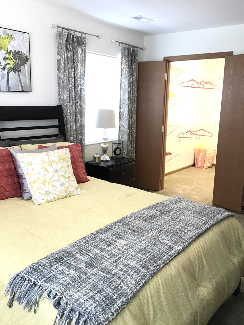 a bedroom with a bed and a closet and a mirror