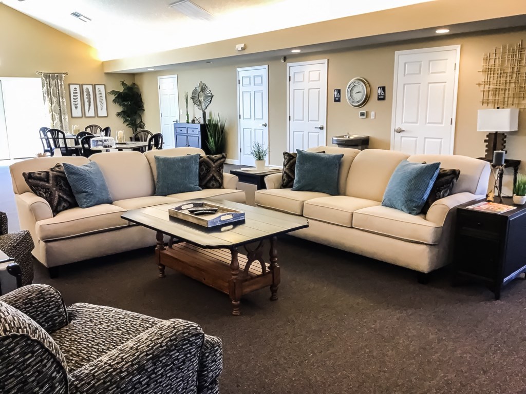 a living room with couches and chairs and a coffee table