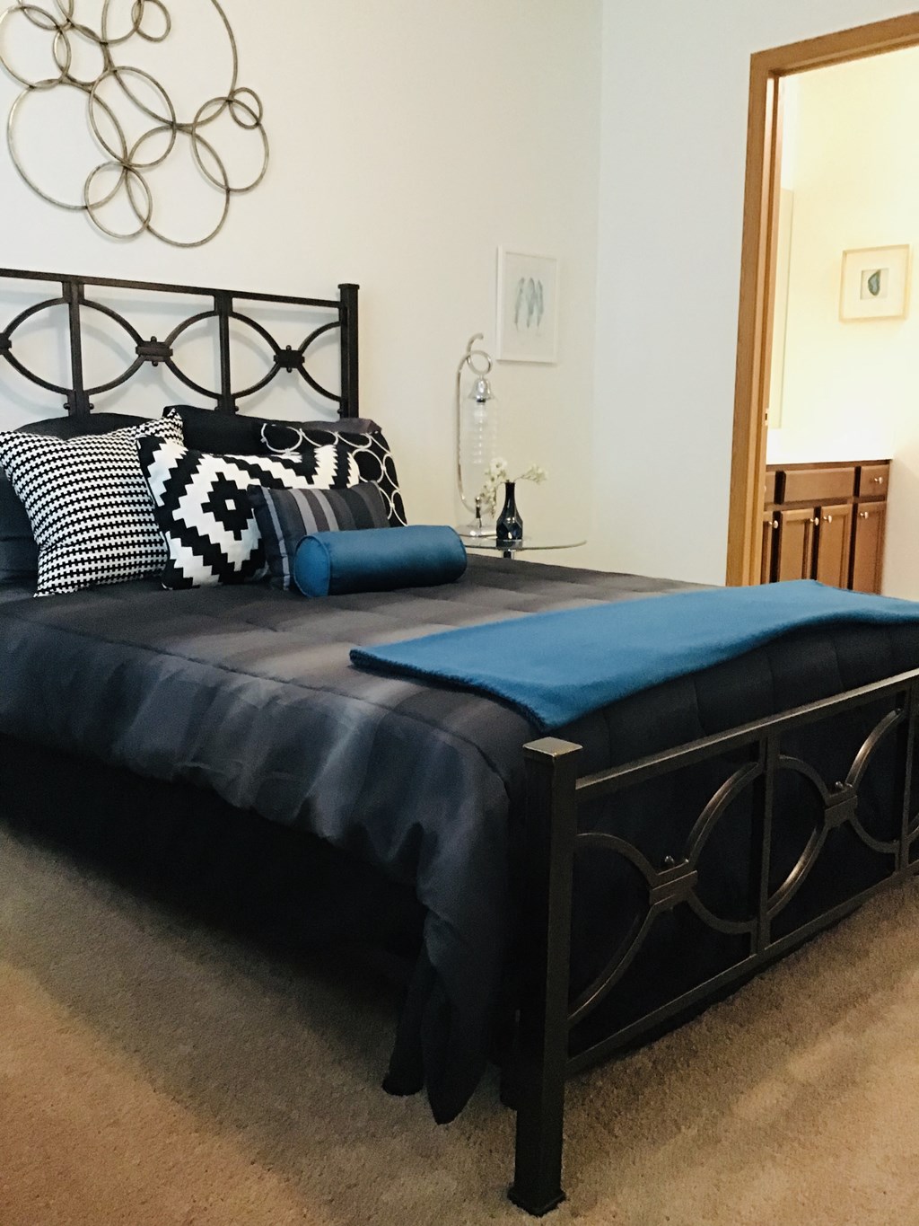 a bedroom with a bed with a blue blanket and pillows