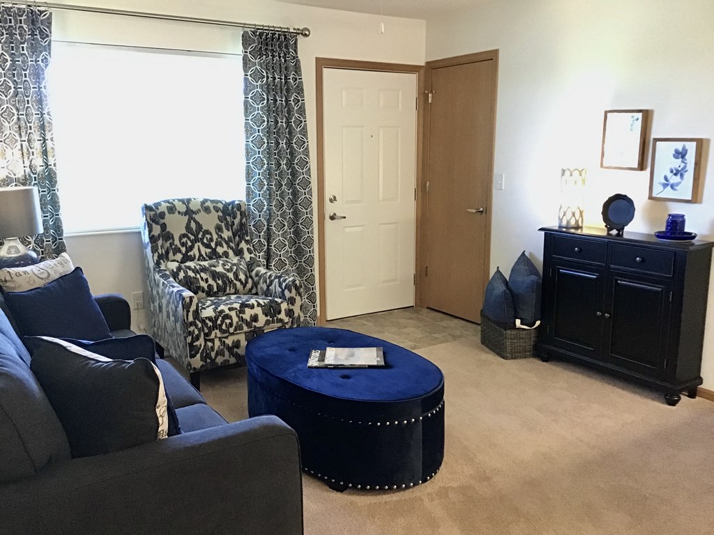 a living room with couches and a blue coffee table