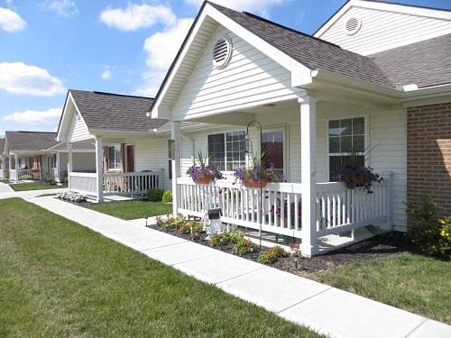 a white house with a sidewalk in front of it