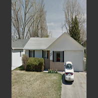 a house with a white car parked in front of it
