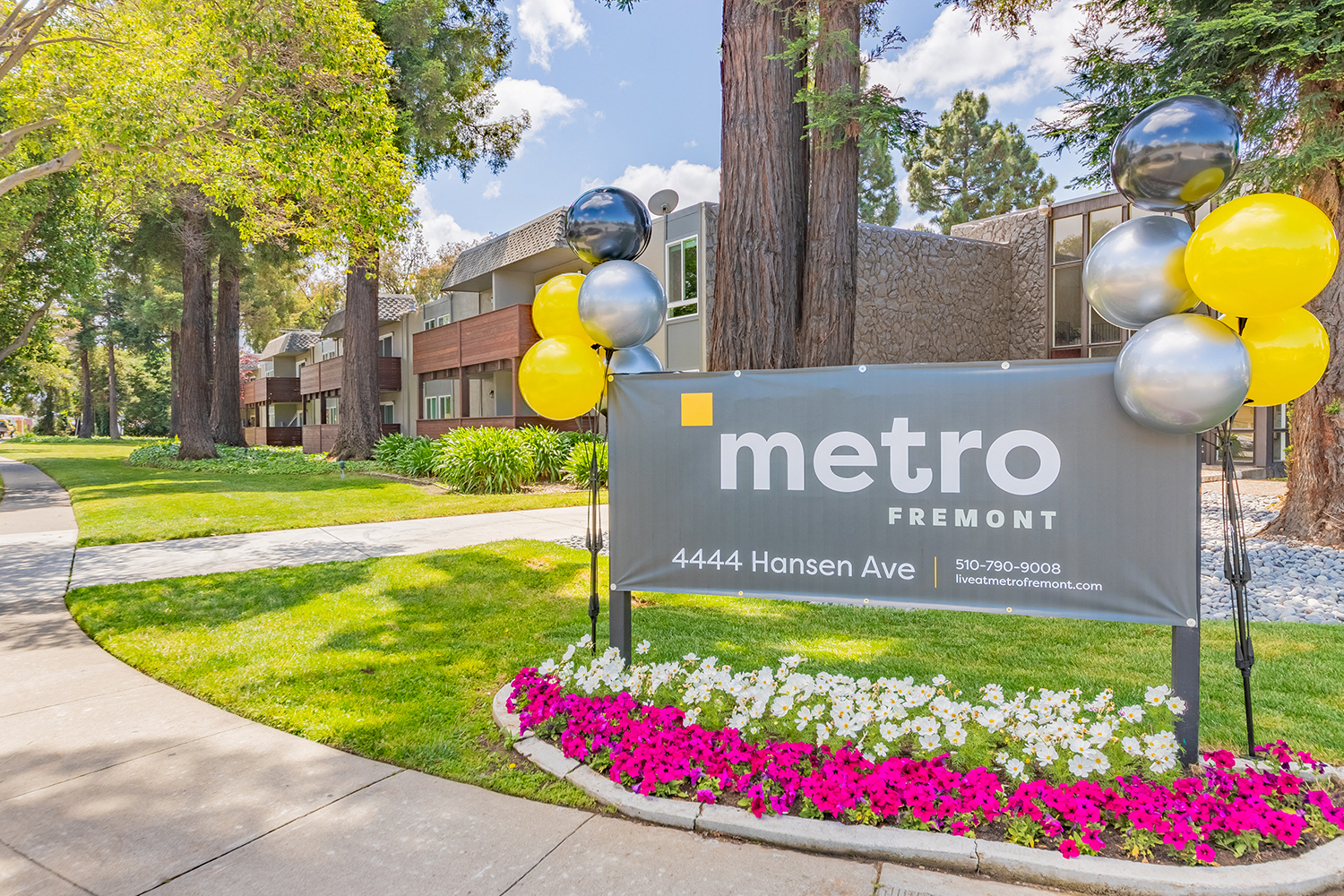 Apartments in Fremont-Metro Fremont Apartments Exterior Of Complex With Paved Walkways And Lush Landscaping And Sign