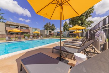 Fremont Apartments for Rent-Metro Fremont Apartments Large Gated Pool Lined With Lounge Chairs And Umbrellas - Photo Gallery 9