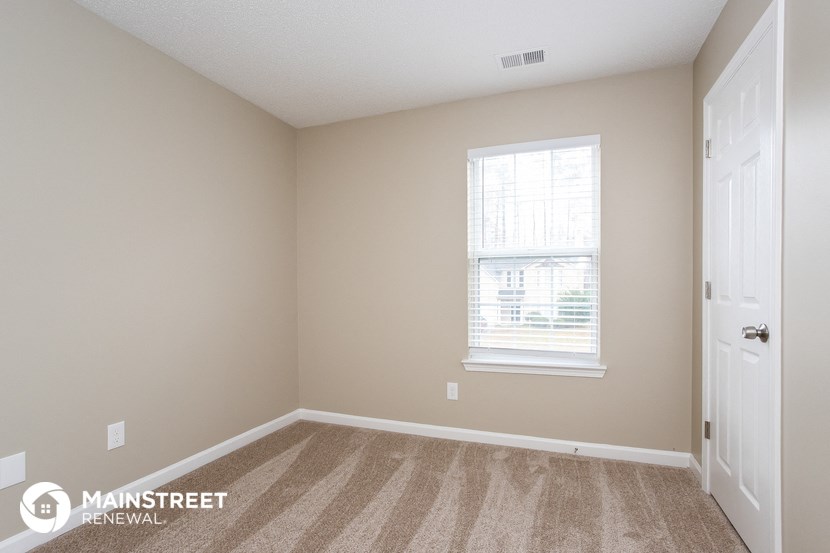 a bedroom with a door and a window