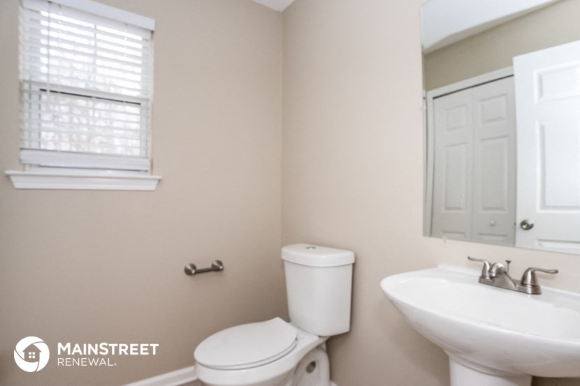 a bathroom with a toilet sink and a window