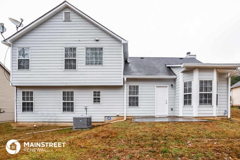 a white house with a yard and a garage