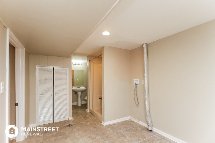 a bathroom with a shower and a toilet and a closet