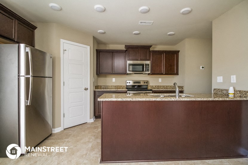 a kitchen with a counter top and a refrigerator