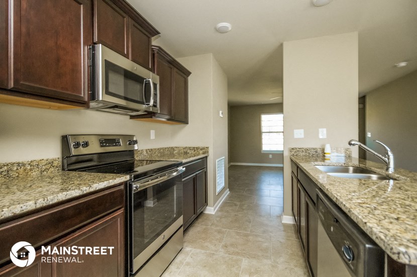 a kitchen with stainless steel appliances and granite counter tops