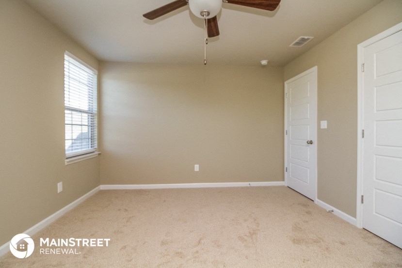 the master bedroom is spacious and has a ceiling fan