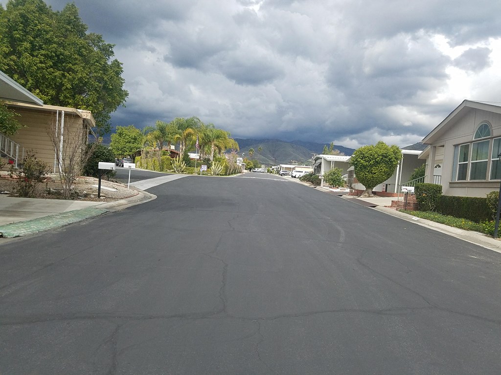 a city street with houses and mountains in the background