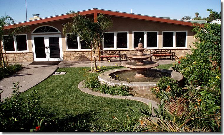 a courtyard with a fountain in front of a building