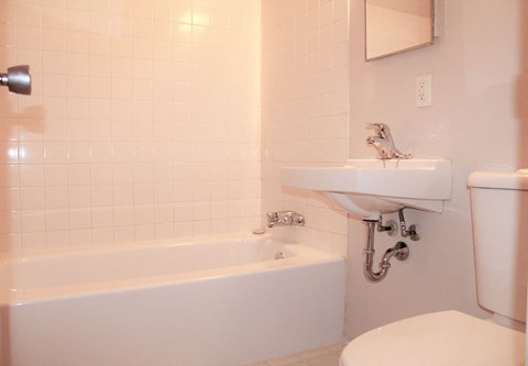 a white bathroom with a sink and a toilet