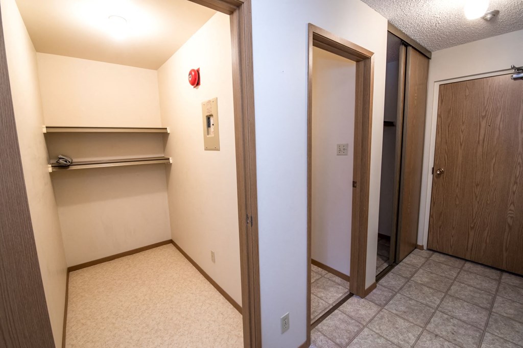 a hallway with two closets and a door to a closet