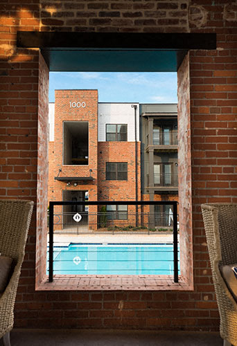 a view of a swimming pool from a window of a building