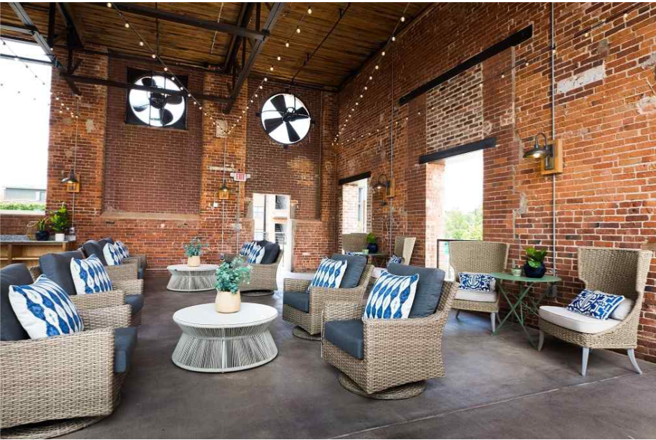 an outdoor patio with chairs and tables in a brick building
