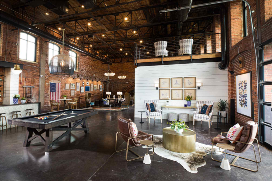 a large room with a ping pong table and a living room