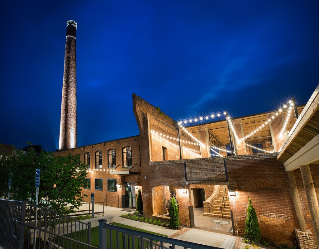 a large brick building with lights on it at night