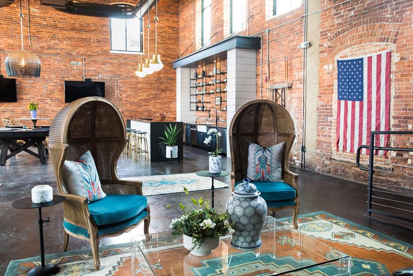 a living room with two chairs and an flag on the wall