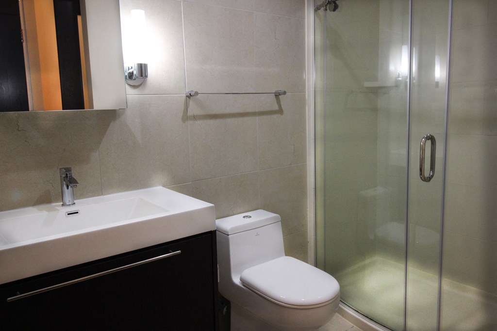 a small bathroom with a sink toilet and shower