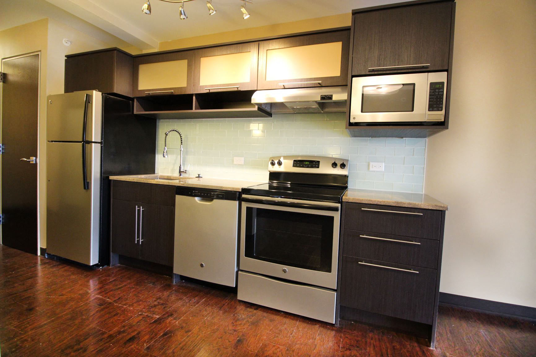 a kitchen with stainless steel appliances and black and white cabinets