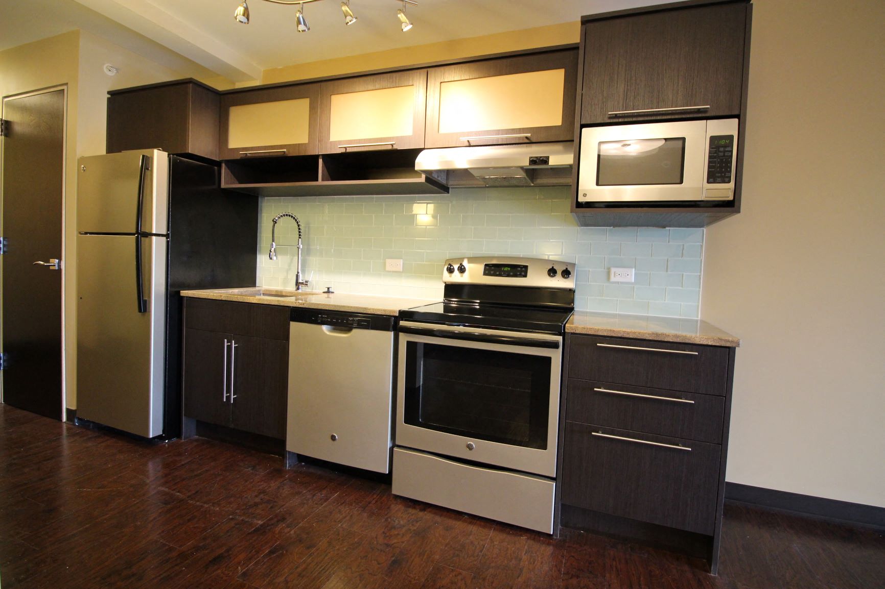 a kitchen with a stove and a refrigerator