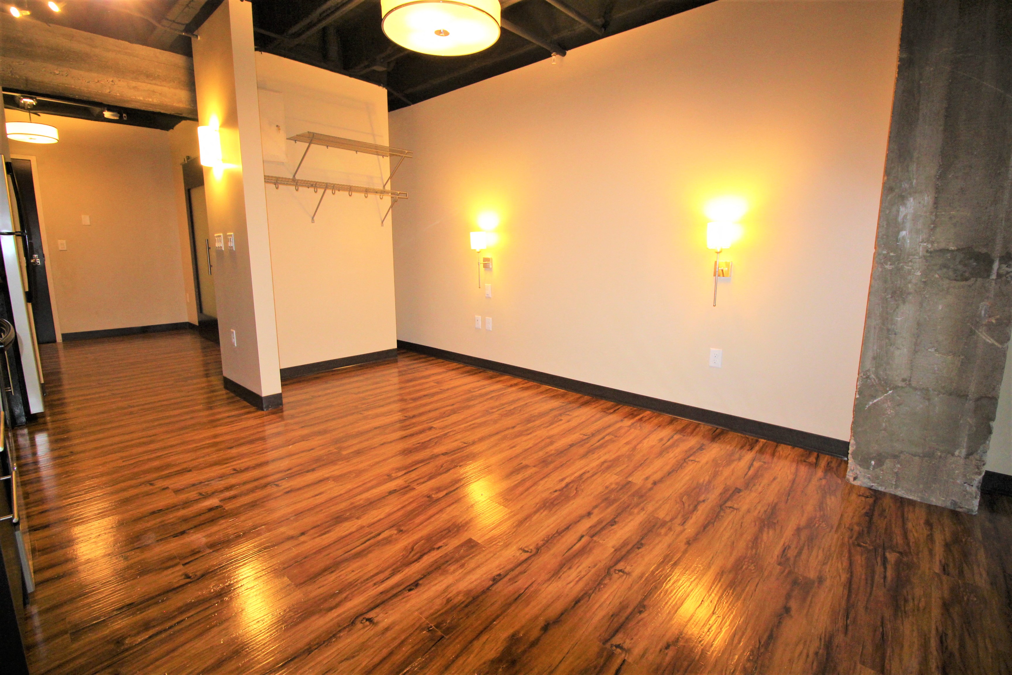 a empty room with a wooden floor and white walls