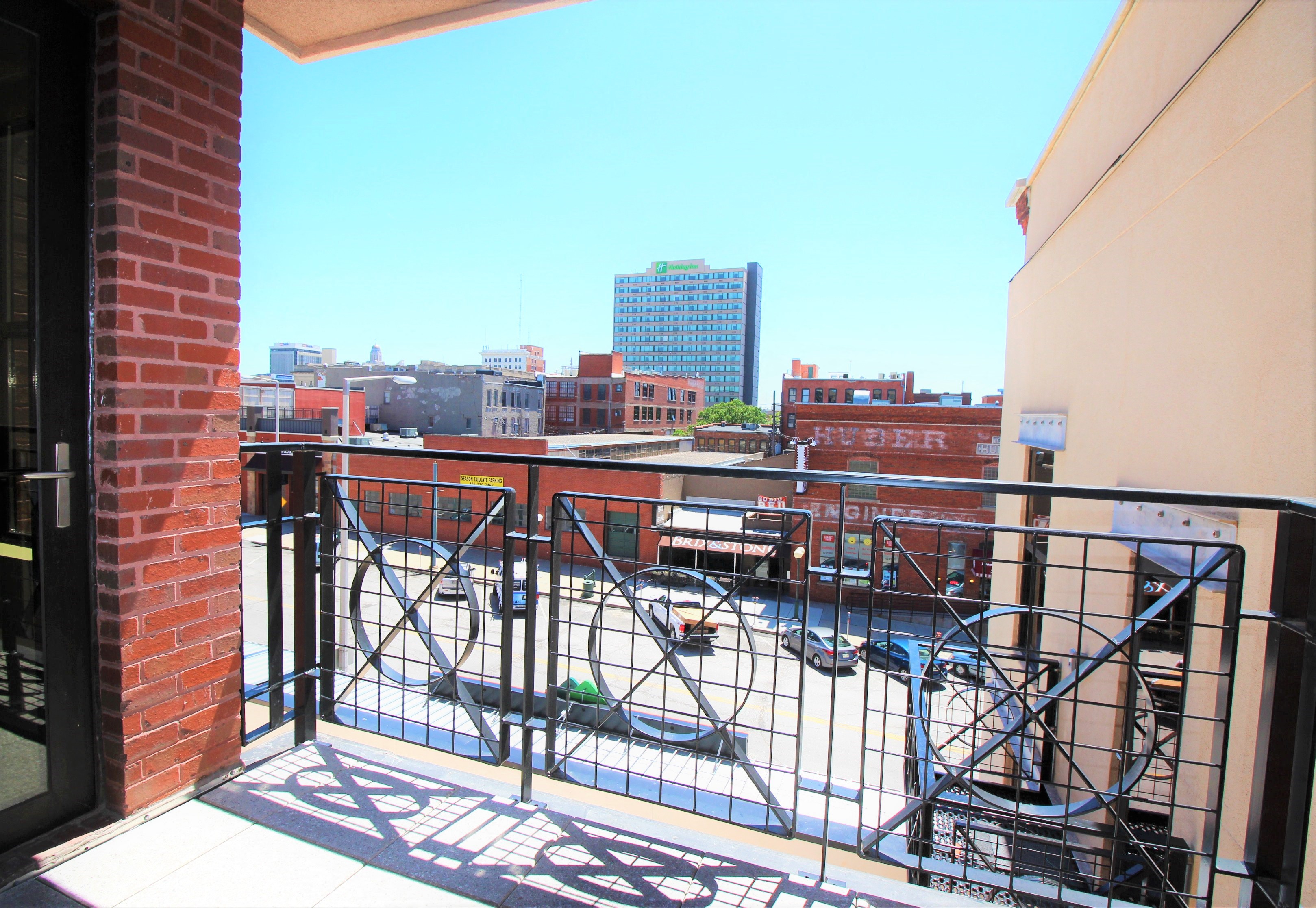 a small balcony with a view of the city